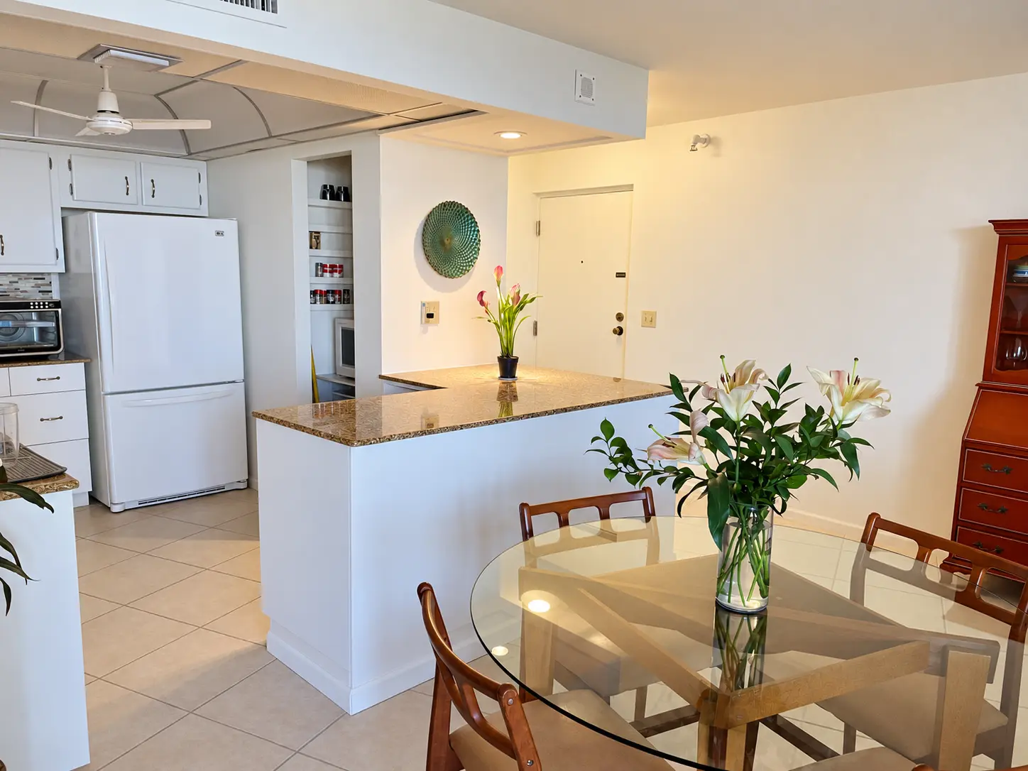 Entry, dining table, and kitchen